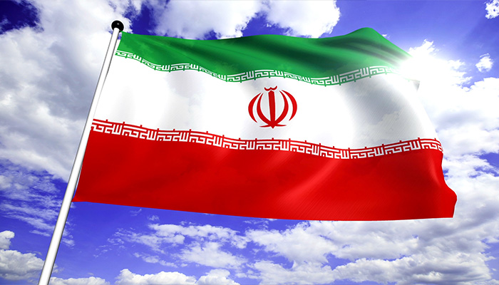 فوتیج پرچم ایران با ساختار پارچه ای در برابر آسمان ابری